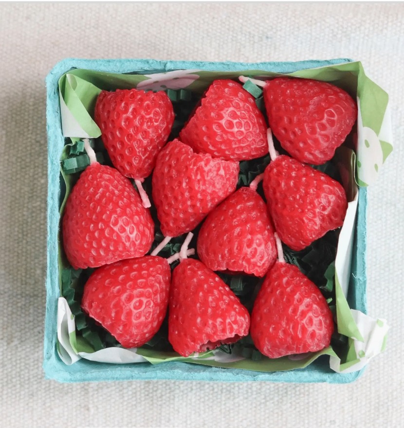 Strawberry beeswax candles packed in a paper berry basket