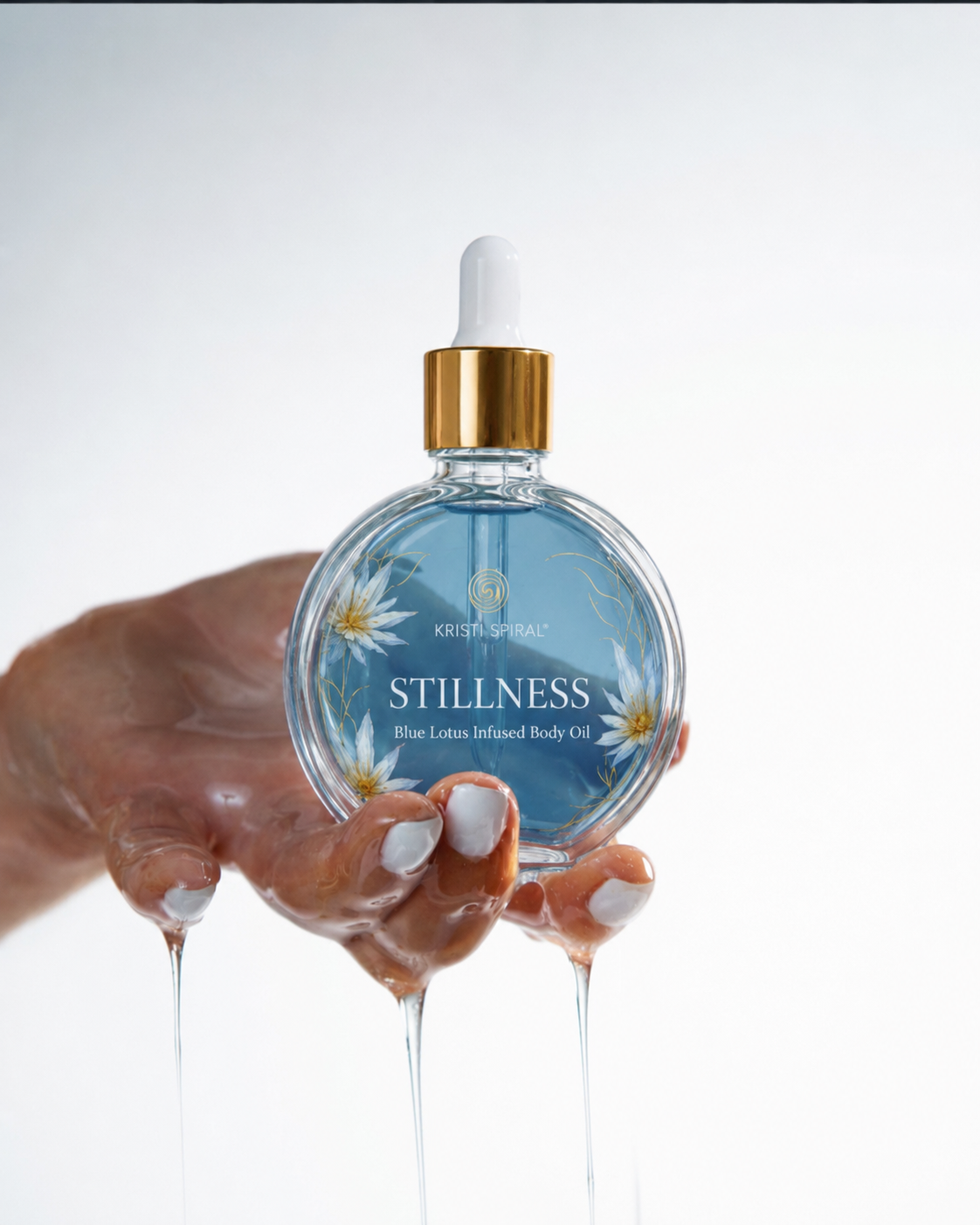 Hands cradling the Stillness Blue Lotus Body Oil bottle